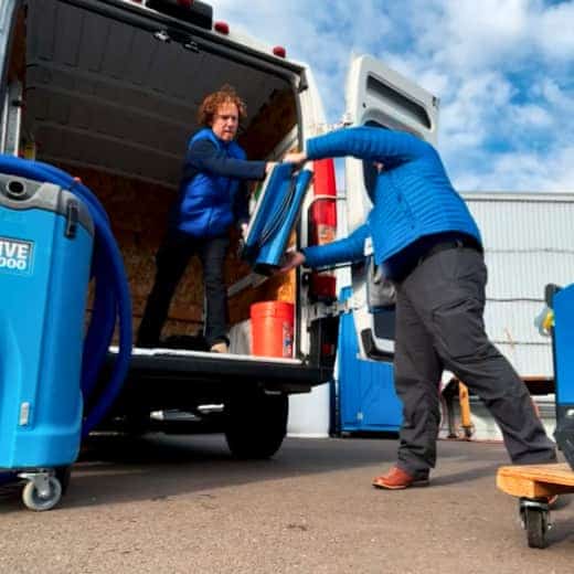 Our IICRC-certified team loads specialized drying equipment into a van, ready to respond to emergency water damage calls