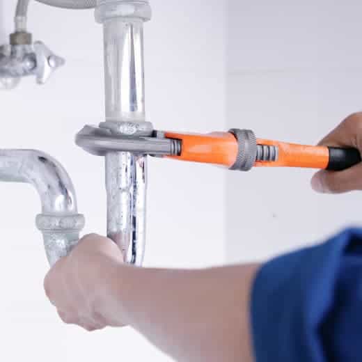 On The Way Plumbing expert securing a pipe joint for a precise, long-lasting leak repair