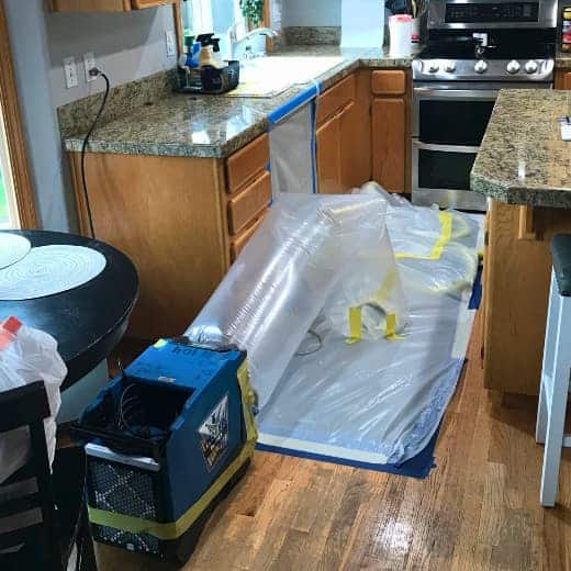 On The Way Plumbing technicians use advanced drying equipment to dry flooring and cabinets in place after a dishwasher leak.